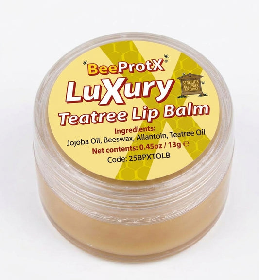 A clear plastic jar of BeeProtX Luxury Teatree Lip Balm, showing the light tan balm inside and a yellow label with red and black text.