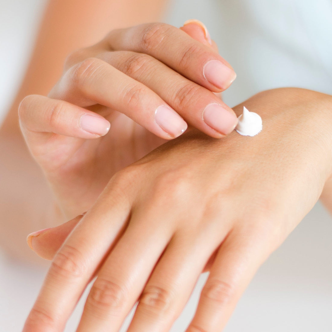 someone applying hand cream for dry chapped skin