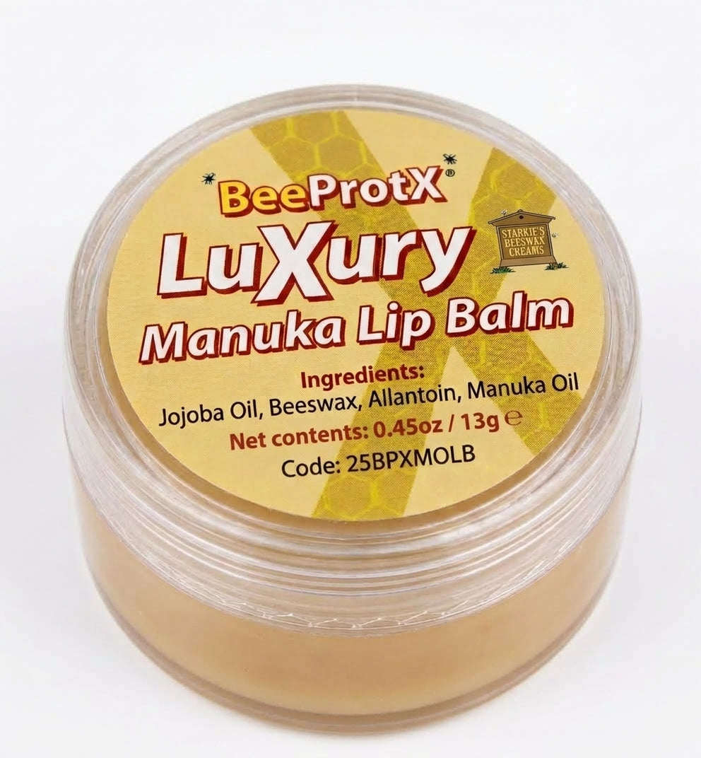 A round clear plastic jar of BeeProtX Luxury Manuka Lip Balm, showing the light tan balm inside and a yellow label with red and white text.