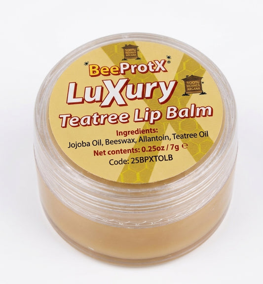 A clear plastic jar of BeeProtX Luxury Teatree Lip Balm, showing the light tan balm inside and a yellow label with red and black text.